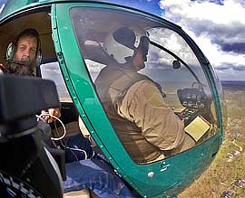 Ed Fink flying in Robinson R-44 helcopter